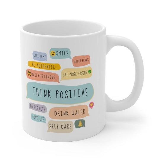 White ceramic mug with 'Think Positive' message printed in a bold, uplifting font. The mug features motivational phrases designed to inspire positivity and encouragement.