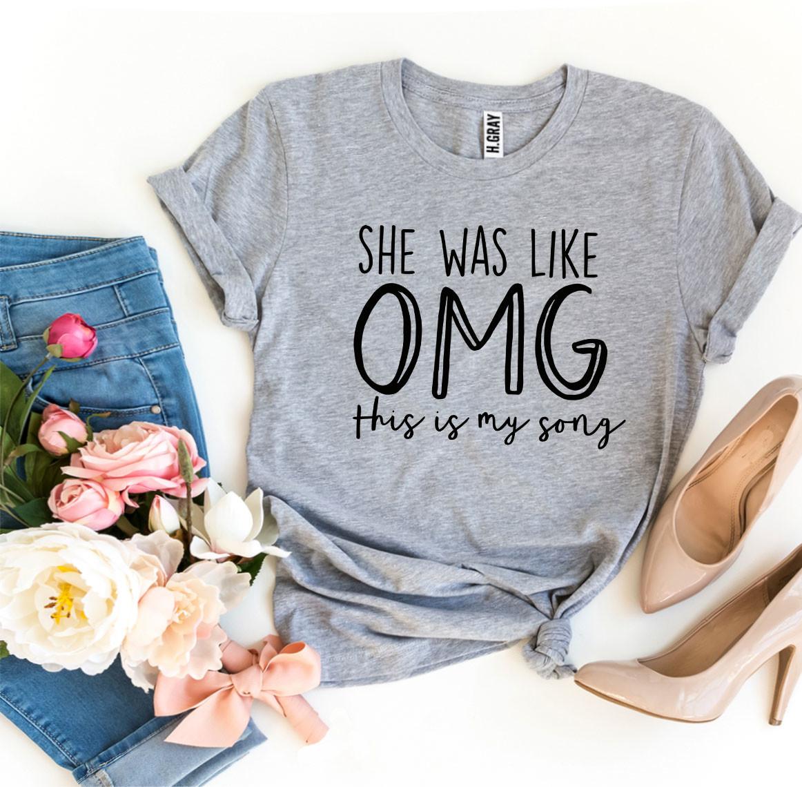 Casual T-shirt featuring the phrase 'She Was Like OMG This Is My Song' in bold, playful lettering. 