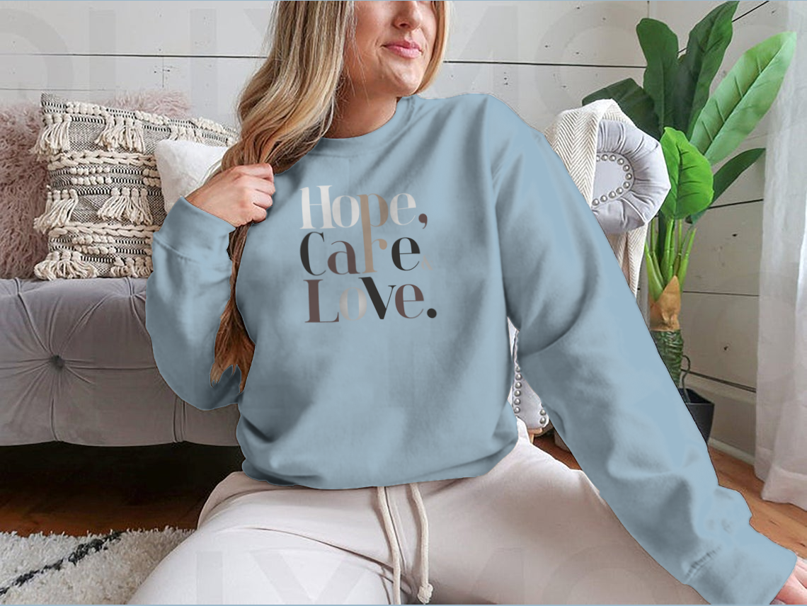 Women wearing a Long-sleeved tee with a modern fashion design featuring the words 'Hope, Care, Love' in a stylish, contemporary font. 